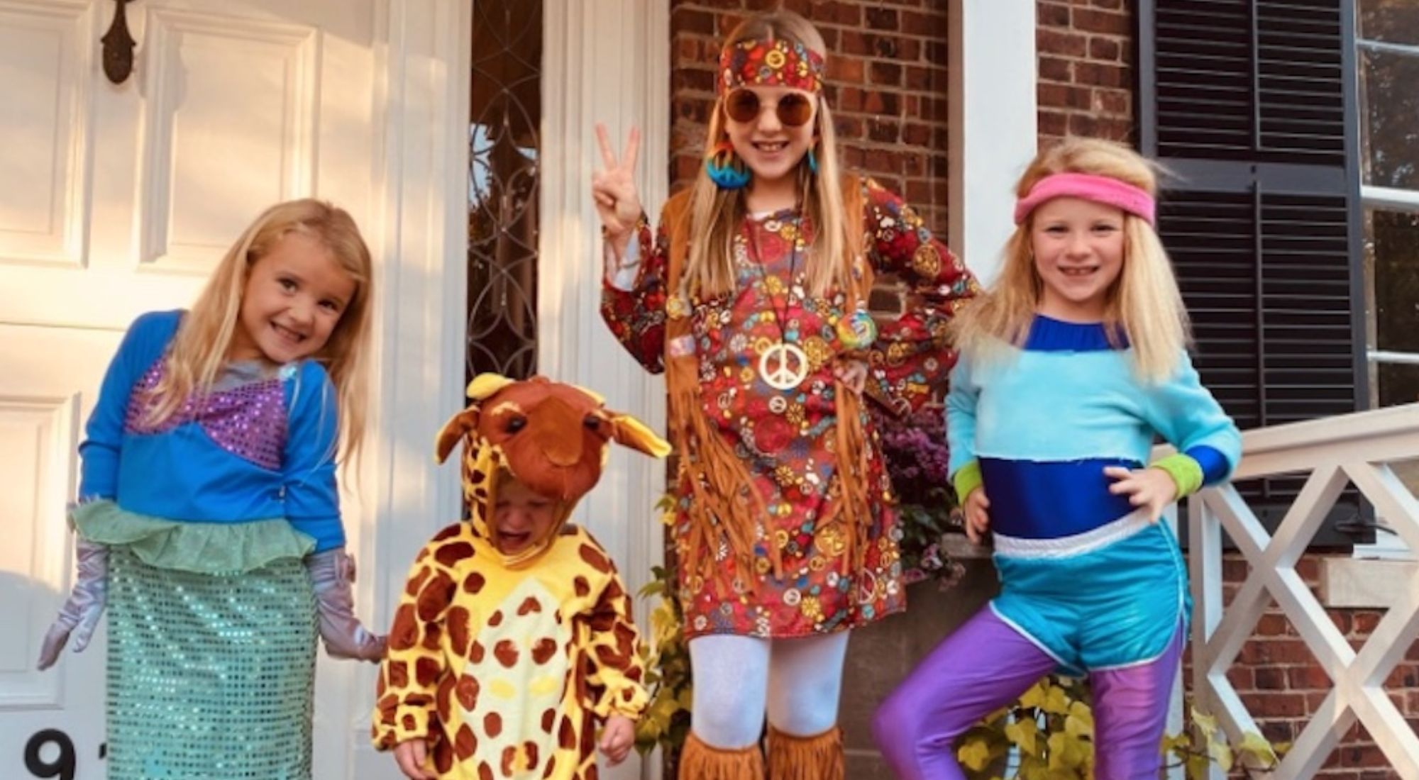 Eli manning's children all dressed up for Halloween on their front porch.