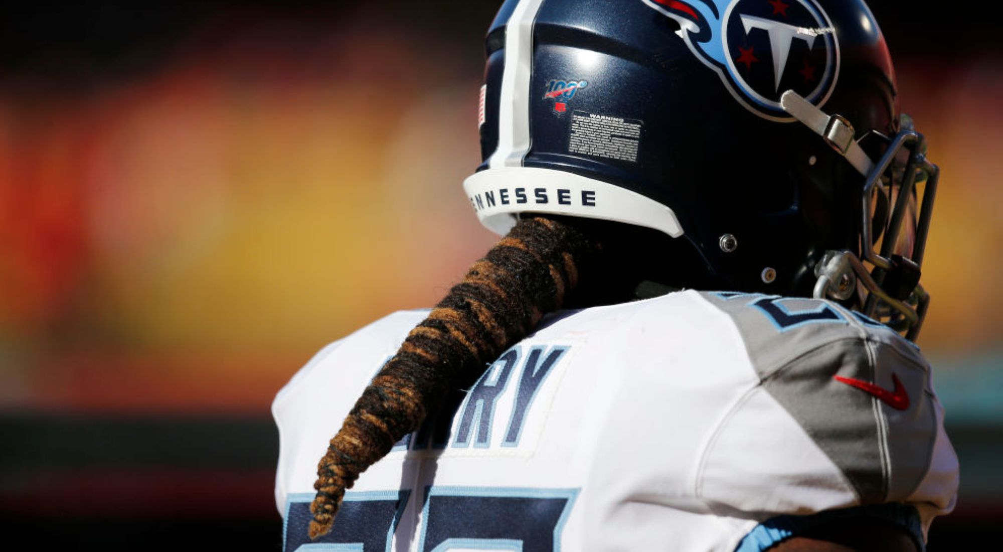 The back of Derrick Henry in a Titans uniform with his hair in a cone shape