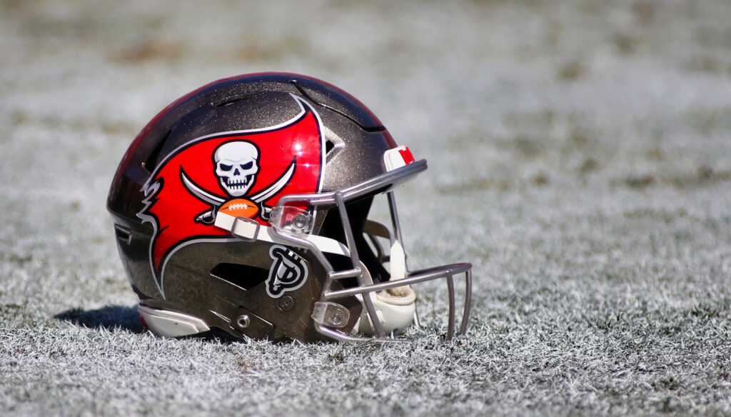 A Tampa Bay Buccaneers helmet and on the ground.