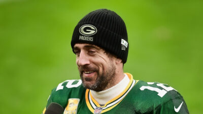 Aaron Rodgers in uniform with skull cap on