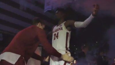 Alabama player patting down another one