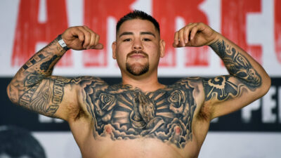 Andy Ruiz shirtless and flexing muscles