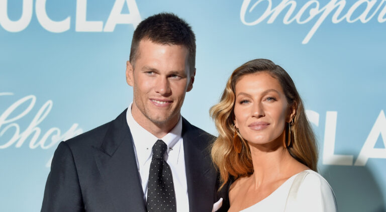 Tom Brady standing next to Gisele Bundchen