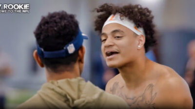 Jalin Hyatt looking at Cowboys scout while shirtless