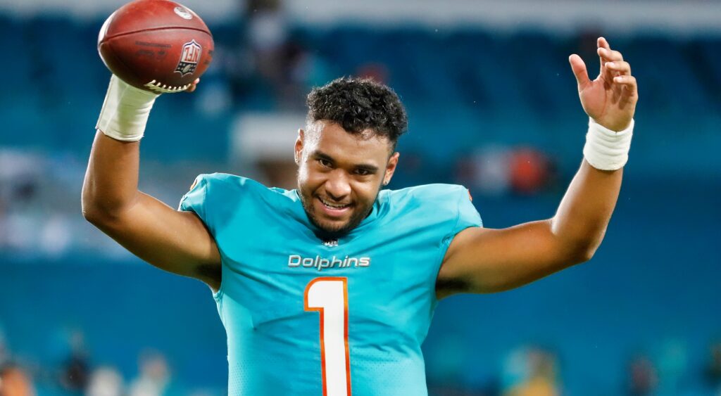 Tua Tagovailoa raises his arms after a win.