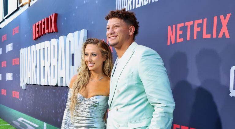 Patrick and Brittany Mahomes posing at Quarterback premiere