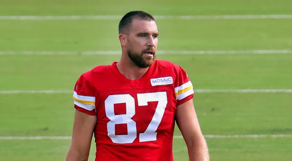 Kansas Chiefs' tight end Travis Kelce walking onto field.