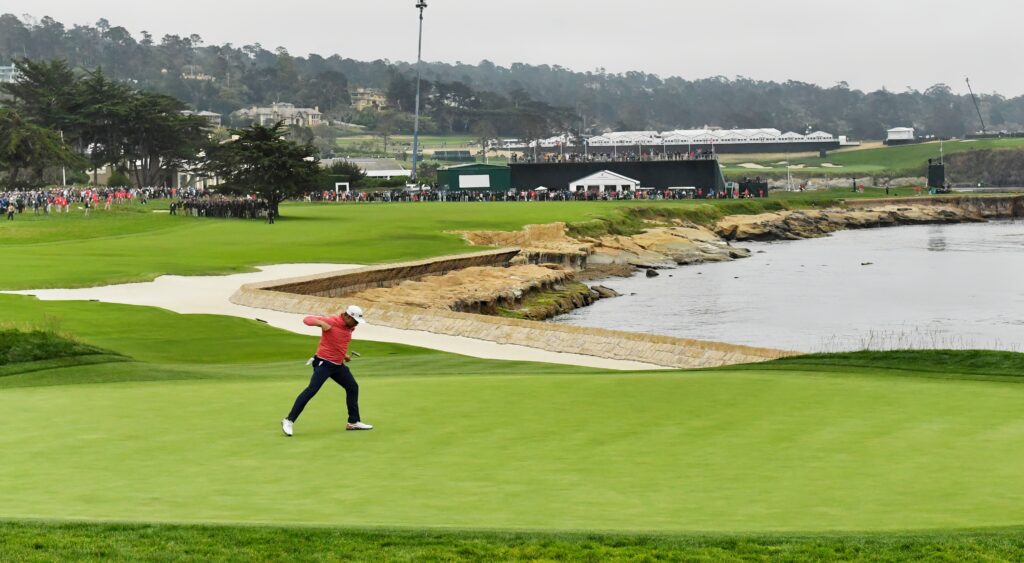 Gary Woodland fist-pumps after draining a tournament-winning putt.