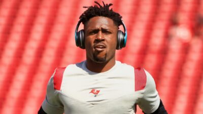 Antonio Brown with headphones on earing Bucs gear