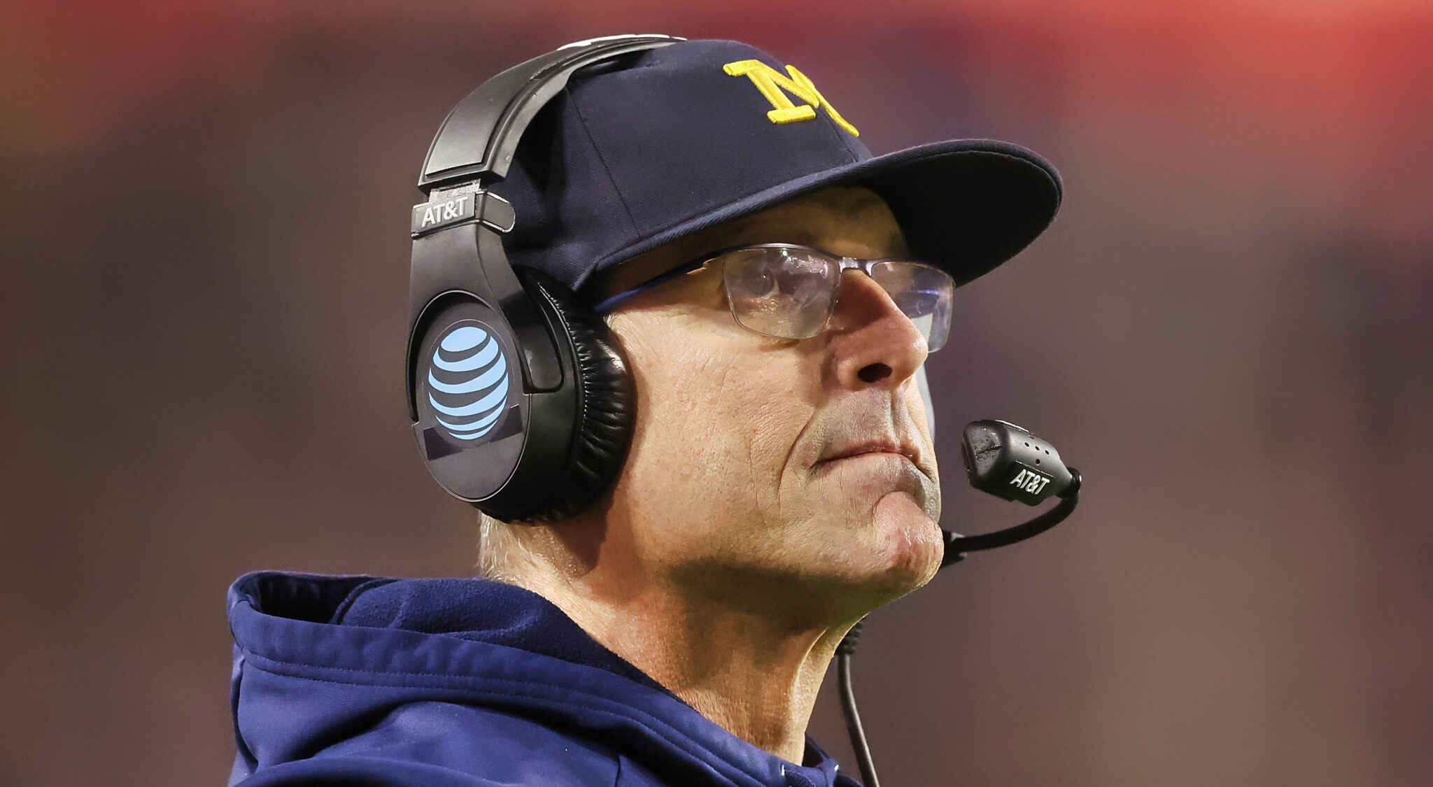 Jim Harbaugh wearing cap and headset