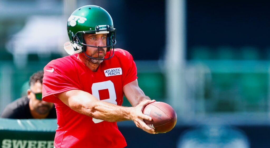 Aaron Rodgers in red jersey at practice