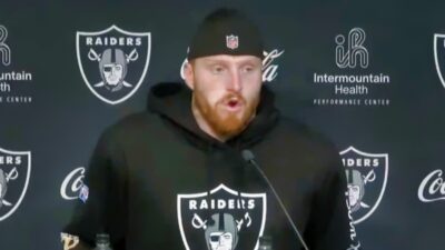 Maxx Crosby in Raiders hoodie speaking to reporters