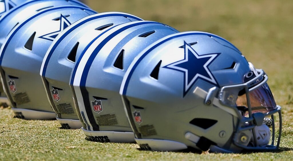 Dallas Cowboys helmets lined up on the field.