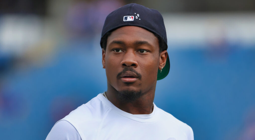 Stefon Diggs wearing an MLB cap backwards