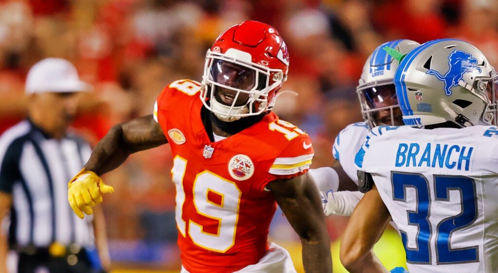 Kadarius Toney looking (left) after Brian Branch (right) intercepts a pass.