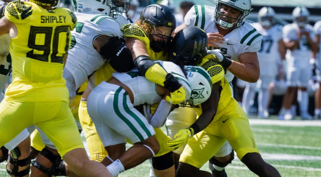 Oregon players tackling Portland State player