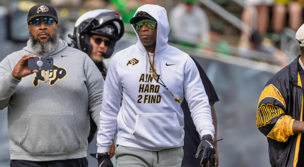 Deion Sanders in hoodie and sunglasses