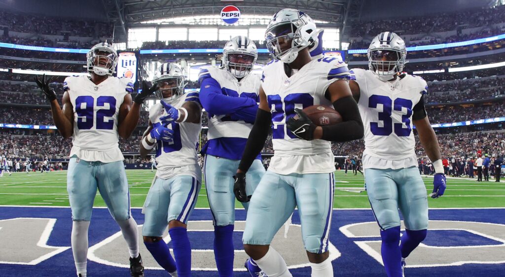 Dallas Cowboys players celebrating after interception.