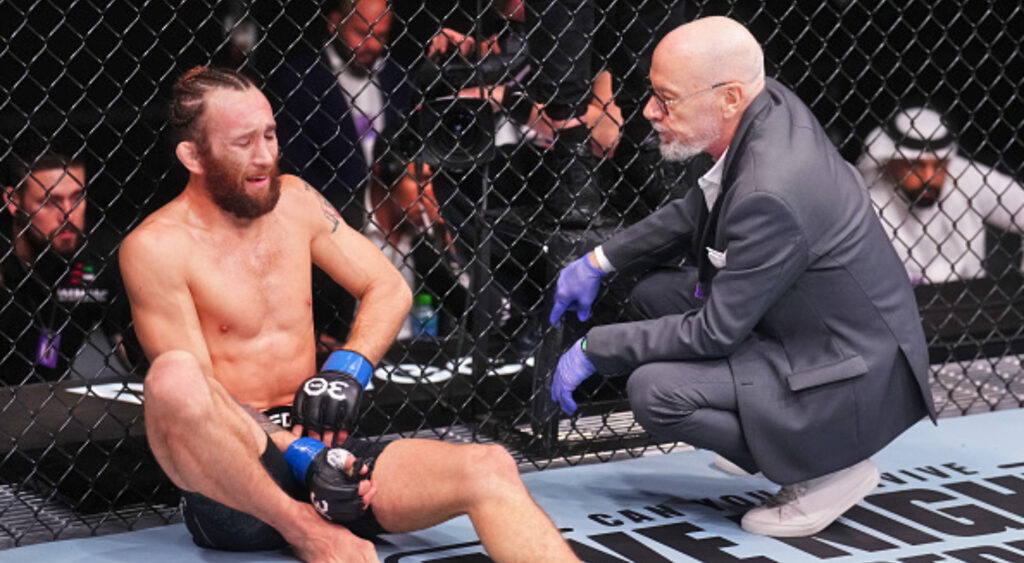 Victor Henry speaking with doctor during UFC match