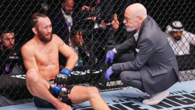 Victor Henry speaking with doctor during UFC match