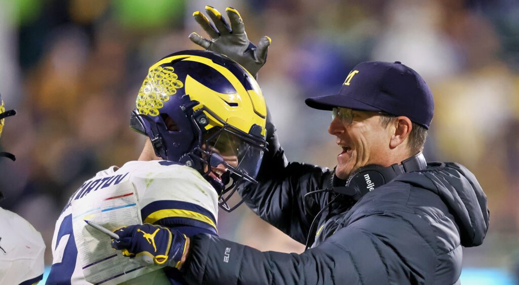 Michigan Wolverines head coach Jim Harbaugh celebrating with J.J. McCarthy.