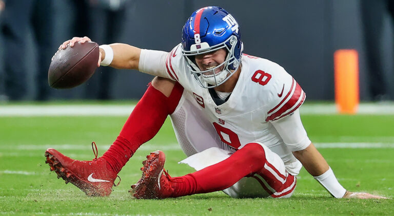 Daniel Jones getting up from football field