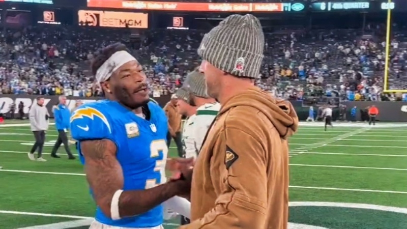 Derwin James (left) speaking to Aaron Rodgers (right).