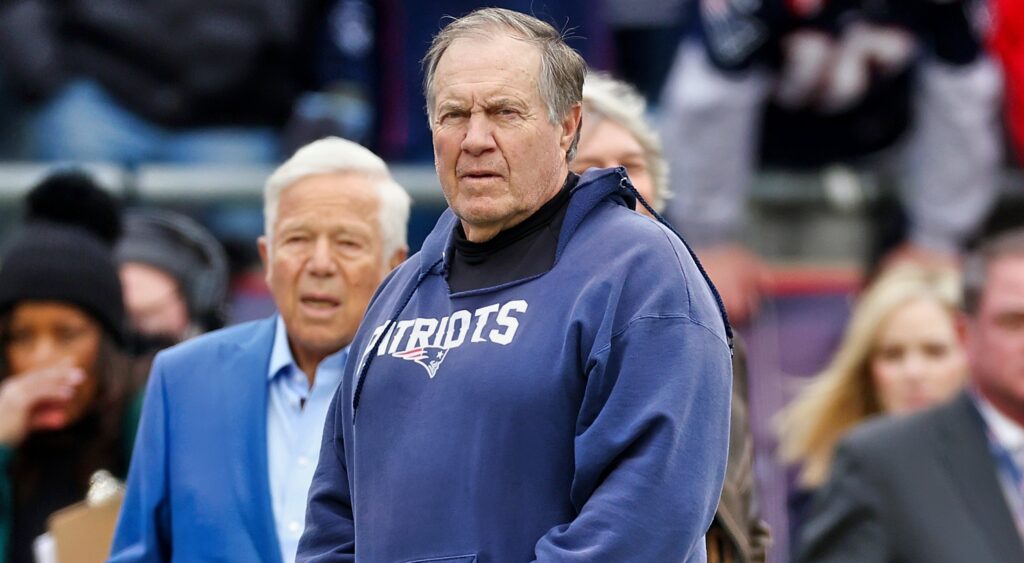 Bill Belichick in Patriots hoodie with Robert Kraft in blue suit