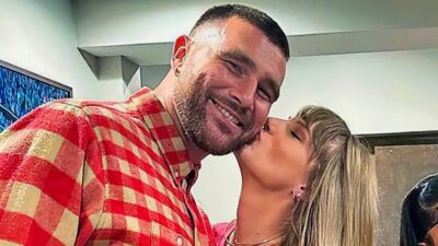 Travis Kelce being kissed by Taylor Swift