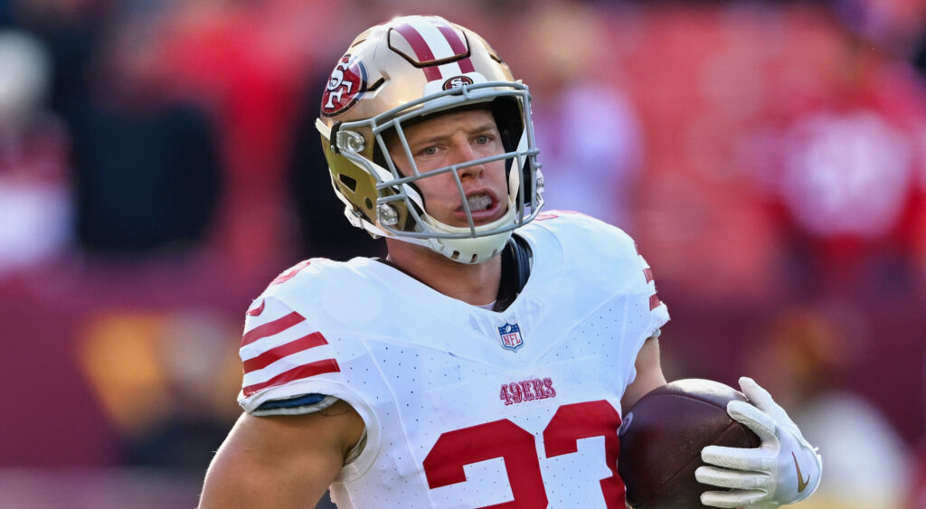 Christian McCaffrey holding a football