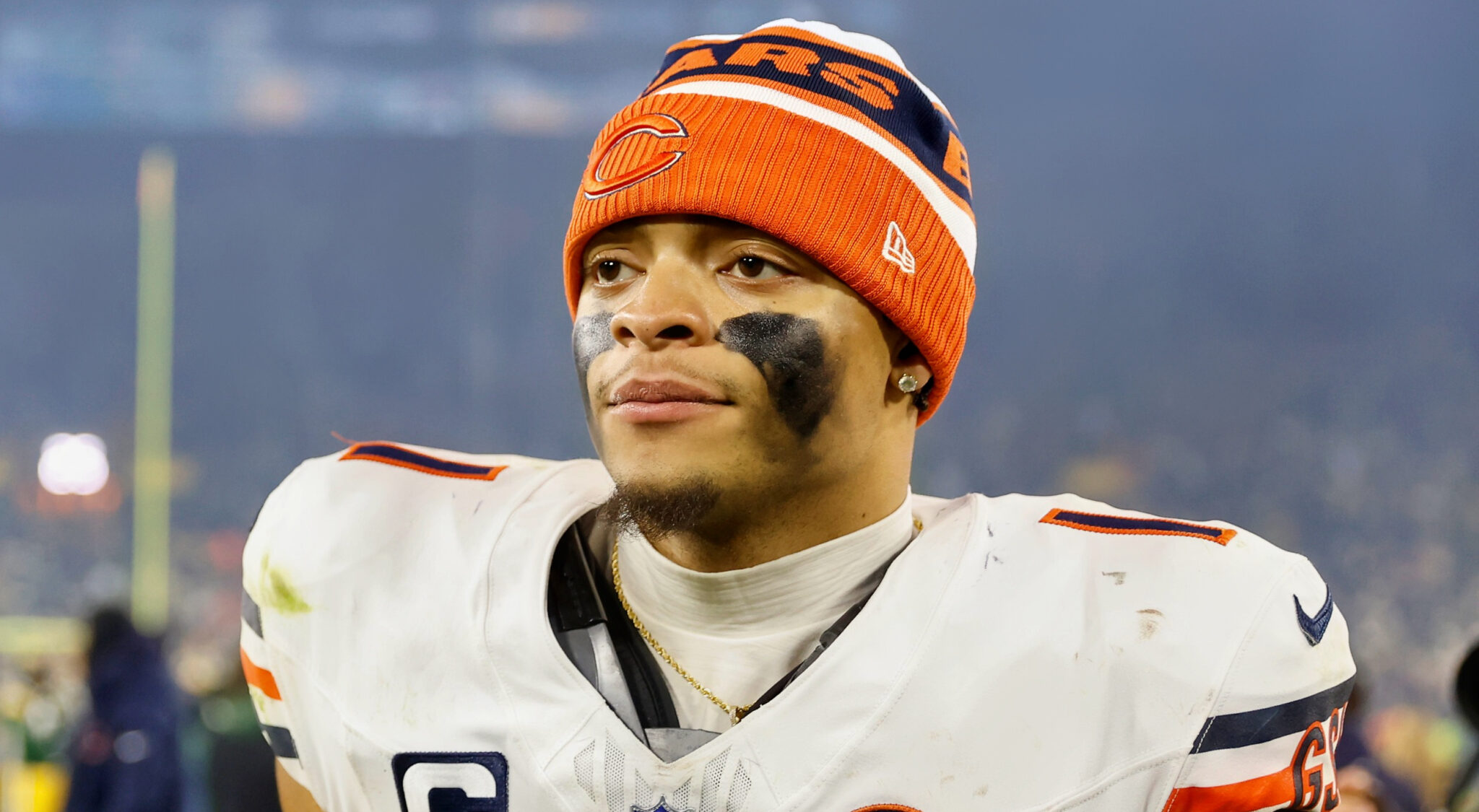 Justin Fields wearing black face paint and Bears beanie