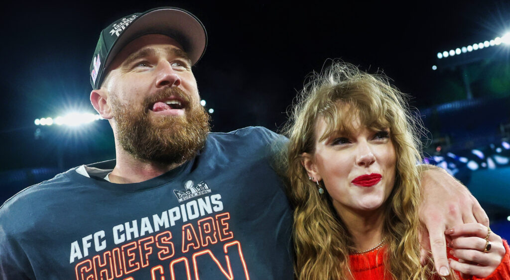 Travis Kelce holding Taylor Swift