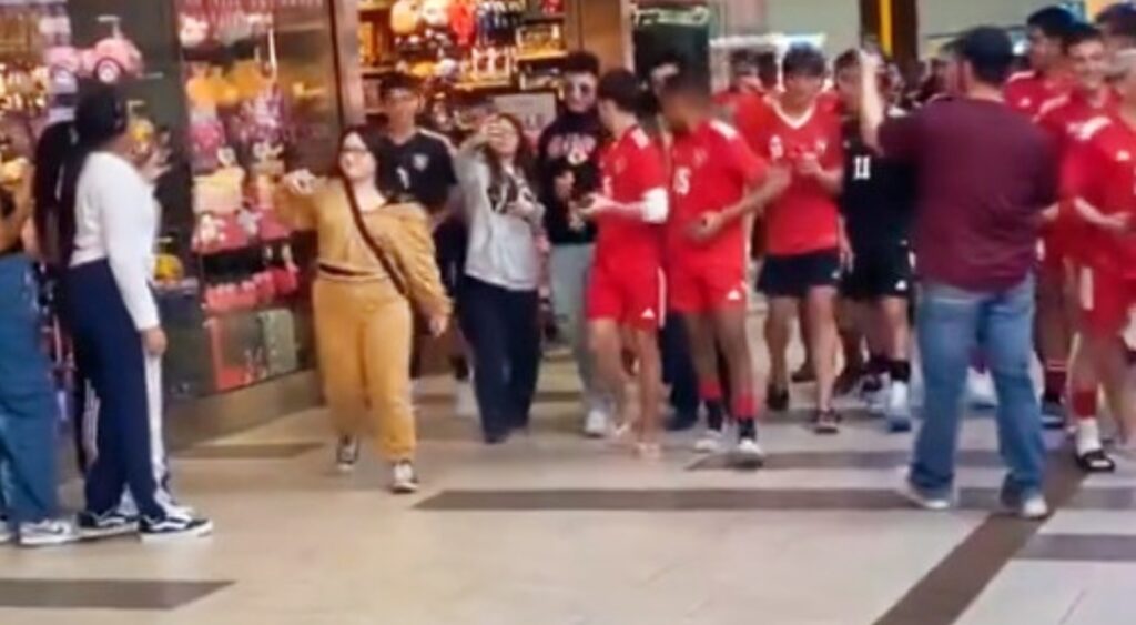 Fake Patrick Mahomes walking through mall surrounding by people