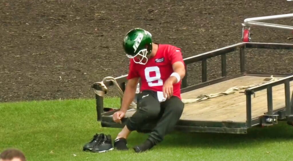 Aaron Rodgers checks on his foot during Jets practice.