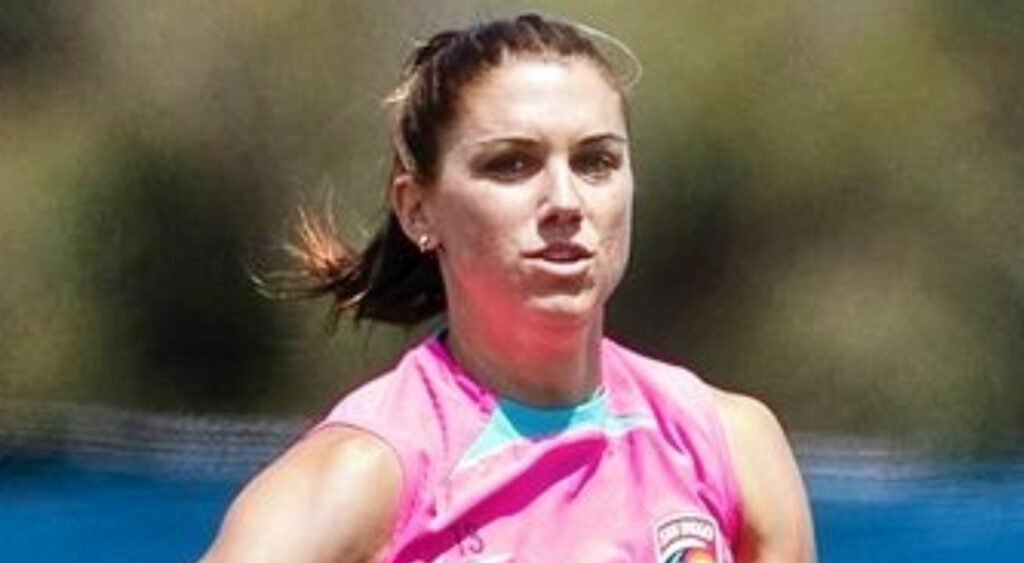 Alex Morgan in pink shirt on field