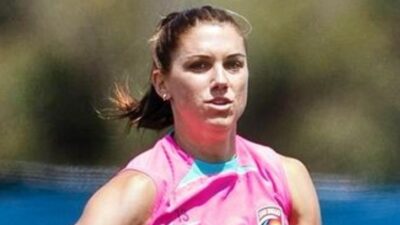 Alex Morgan in pink shirt on field