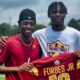 Emmanuel Forbes holding his jersey up with a fan