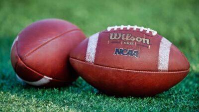 NCAA footballs on ground