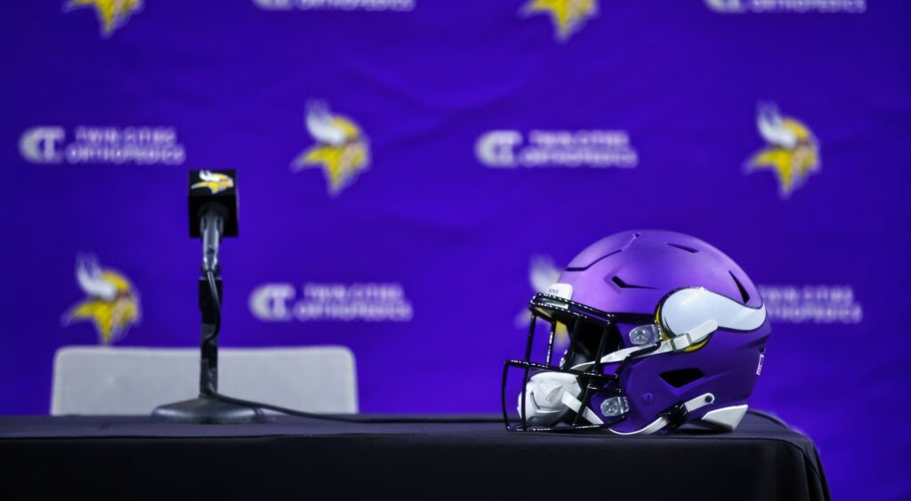 Minnesota Vikings helmet on a table at a press conference.