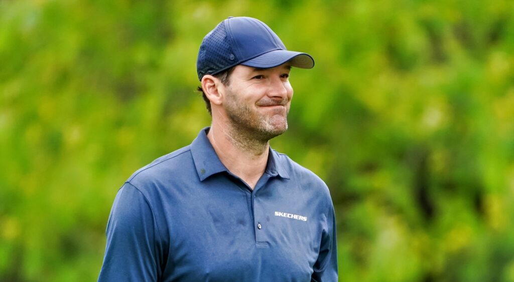 Tony Romo looking on at golf event.