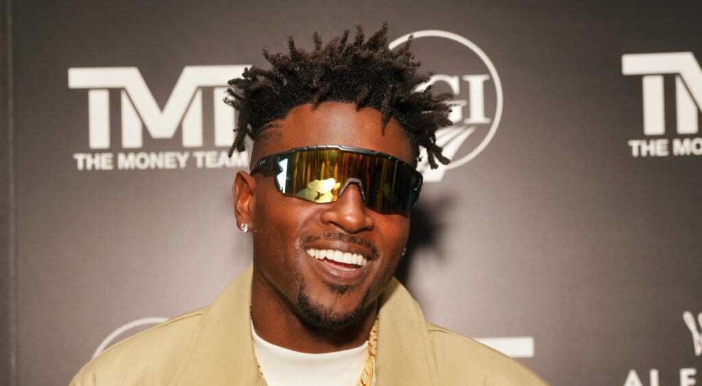 Former NFL wide receiver Antonio Brown smiling at event.