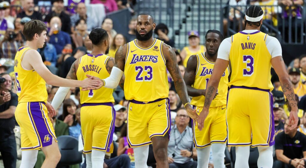 Los Angeles Lakers stars Austin Reaves, LeBron James and Anthony Davis shake hands.