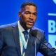 Michael Strahan speaking into mic