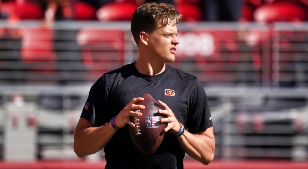 Joe Burrow holding football in practice