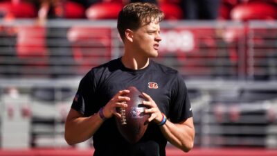 Joe Burrow holding football in practice