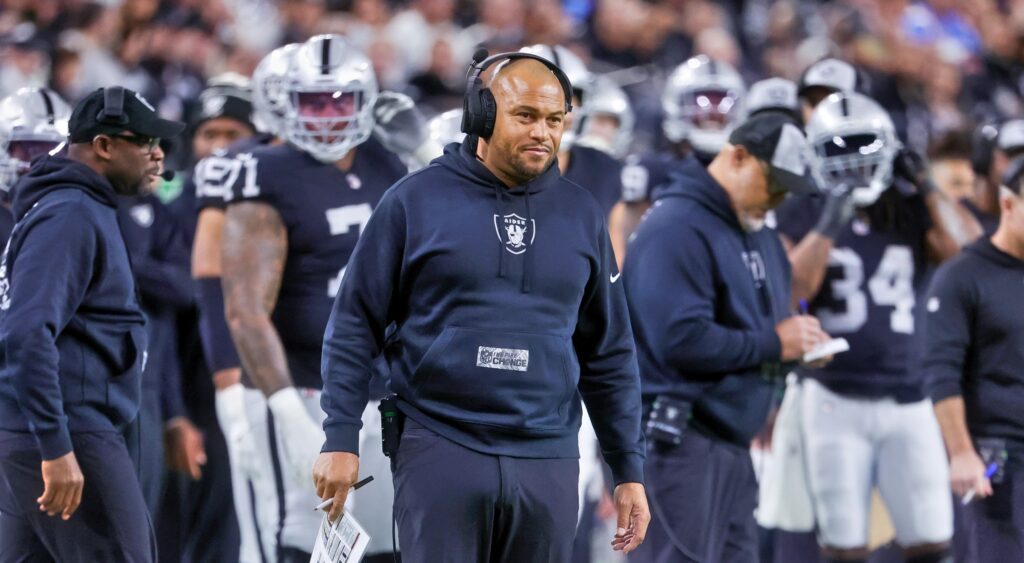 Las Vegas Raiders head coach Antonio Pierce looking on.