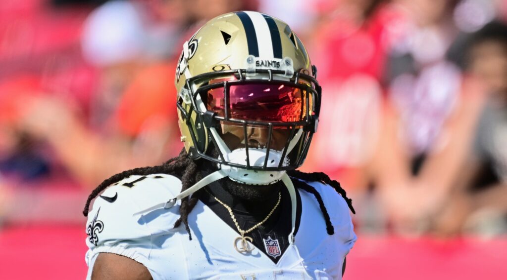 New Orleans Saints running back Alvin Kamara looking on.