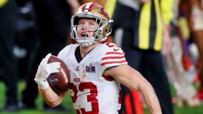 Christian McCaffrey running with a football