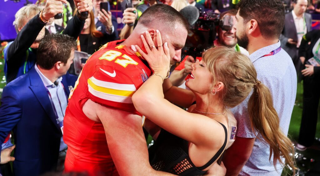 Travis Kelce and Taylor Swift hugging and kissing