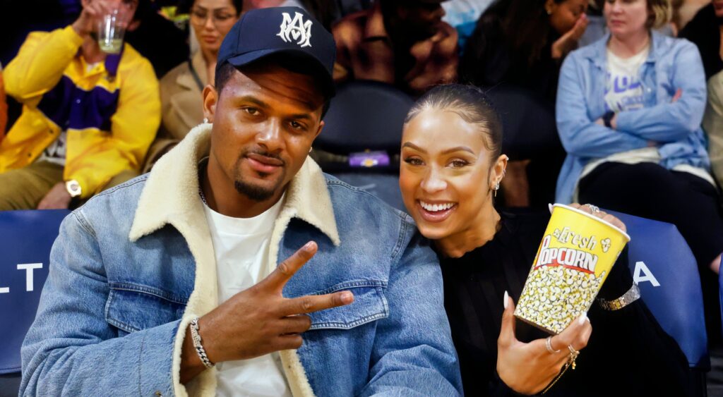 Deshaun Watson and Jilly Anais sitting courtside at a basketball game.